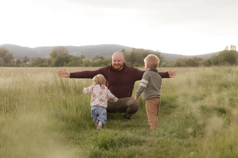 Jamie Murphy with his two kids in a field at golden hour
